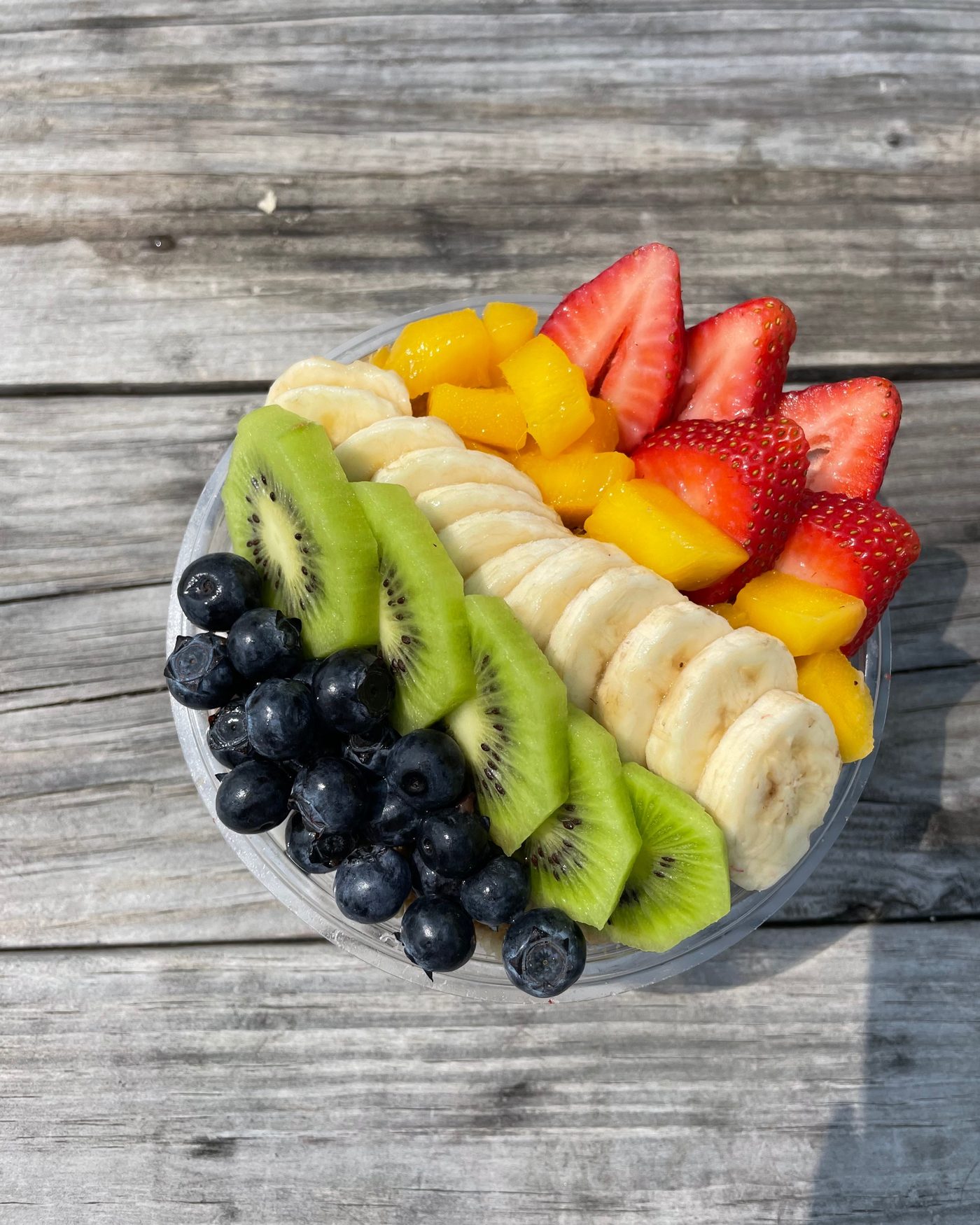 An acai bowl topped with banana, strawberry, blueberry and granola